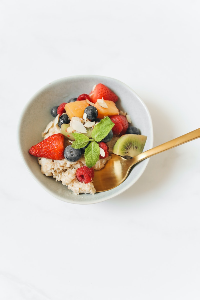 Oatmeal with Sliced Fresh Fruits in a Ceramic Bowl